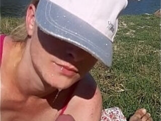 His wife sucks his dick while on the beach to tan his skin. The wife was scared because she was in public and she was scared not to be seen by others.